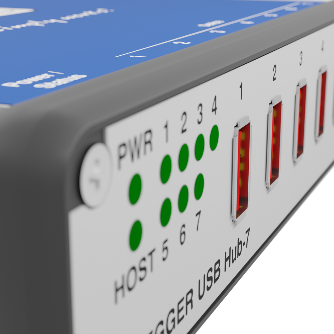 A close-up view of a USB hub with seven ports. The front features labeled ports numbered 1 through 7, alongside power and host indicators. Green LEDs display power status, and a white section indicates the model name "Trigger USB Hub-7."