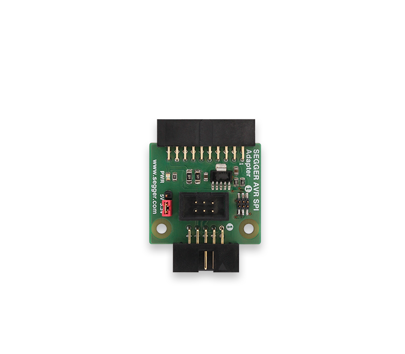 AVR SPI Adapter Image of a SEGGER AVR SPI adapter featuring a green circuit board with various electronic components, connectors, and pins. The adapter is typically used for programming and debugging AVR microcontrollers. The design includes labels for power and signal pins.
