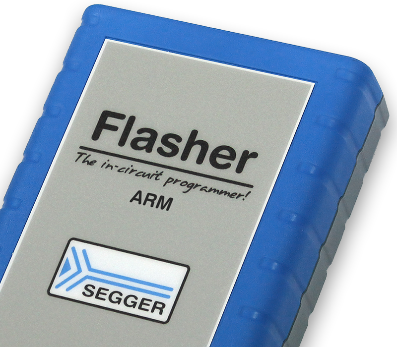 Flasher ARM Image of a rectangular device labeled "Flasher" with the tagline "The in-circuit programmer!" and "ARM". The device has a gray front with rounded edges and a blue rubber case, along with a logo indicating "SEGGER" at the bottom.